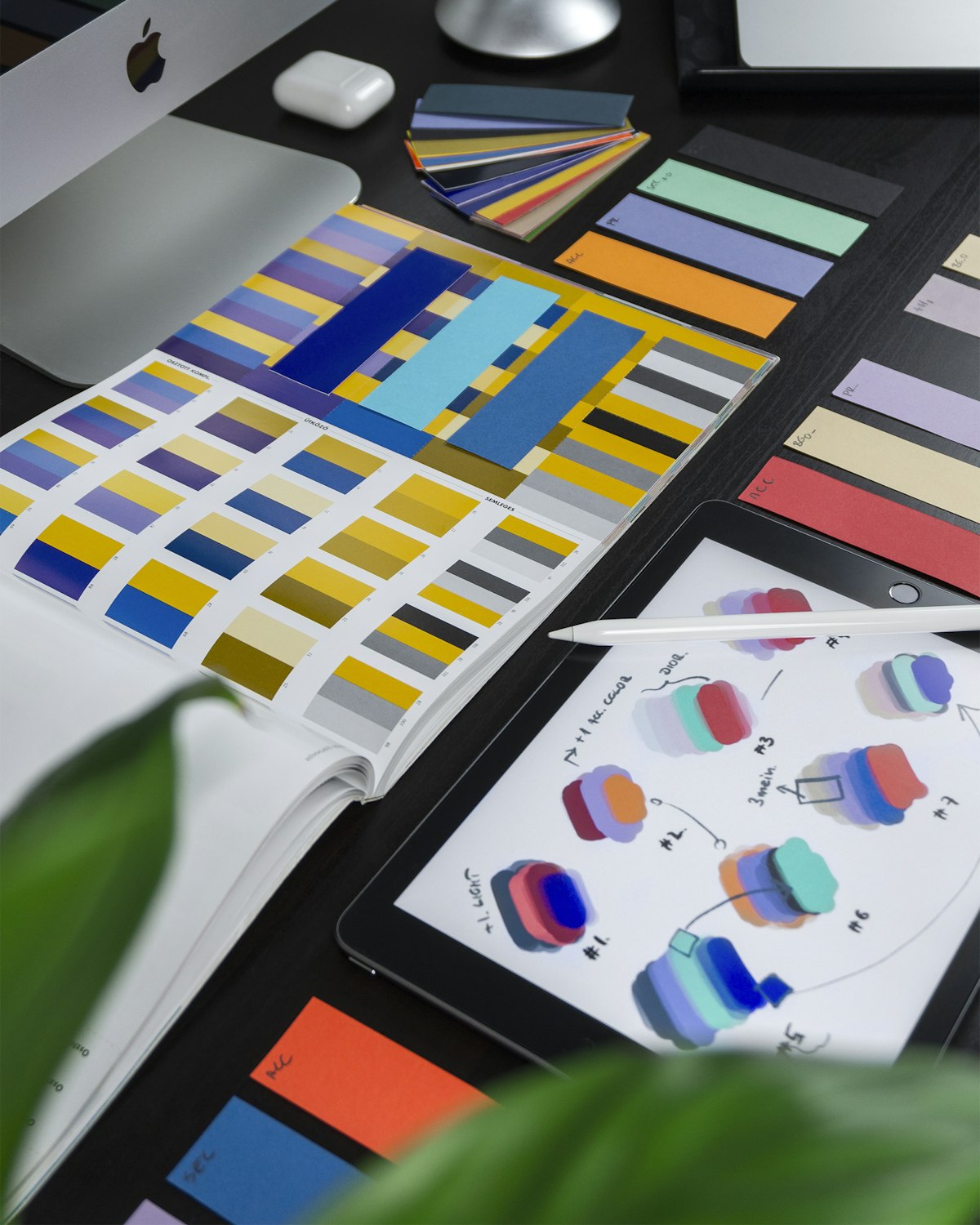 A design desk with color swatches and a computer